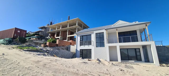 Window and door frames installed across a large new-home facade