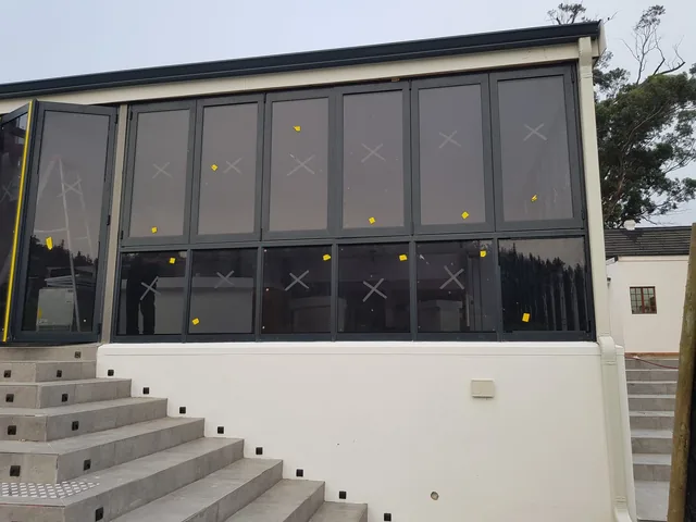 Black aluminium window wall on a white exterior