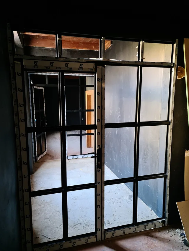 Black metal security gate at an interior entrance