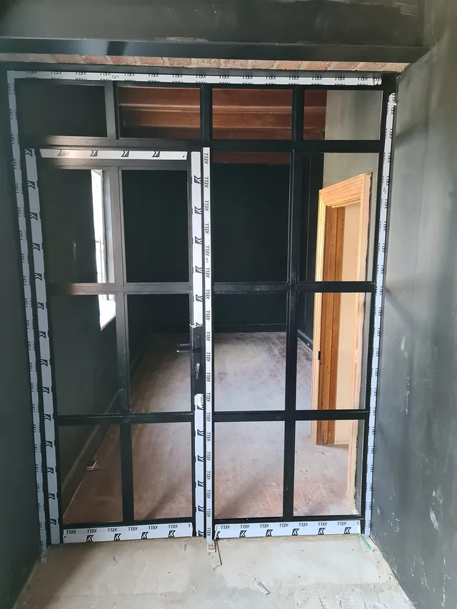 White metal security gate fitted inside an entrance