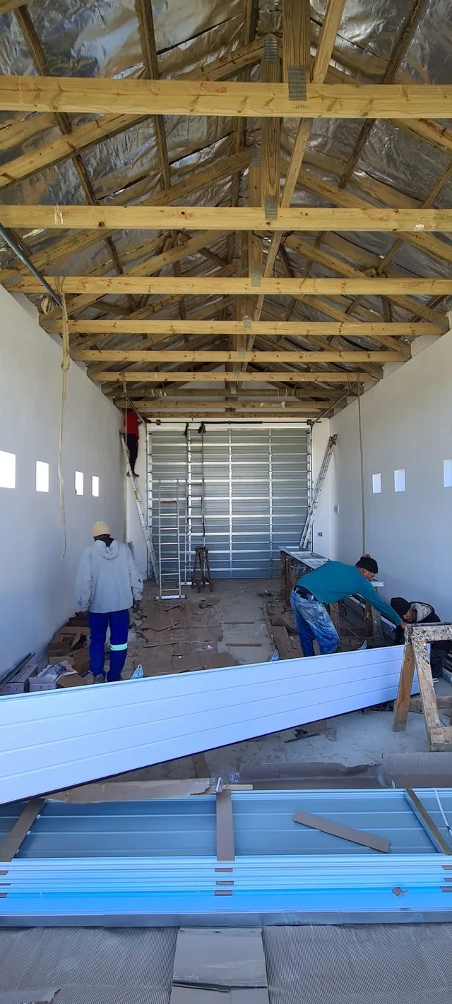 White sectional garage door below a gabled roof